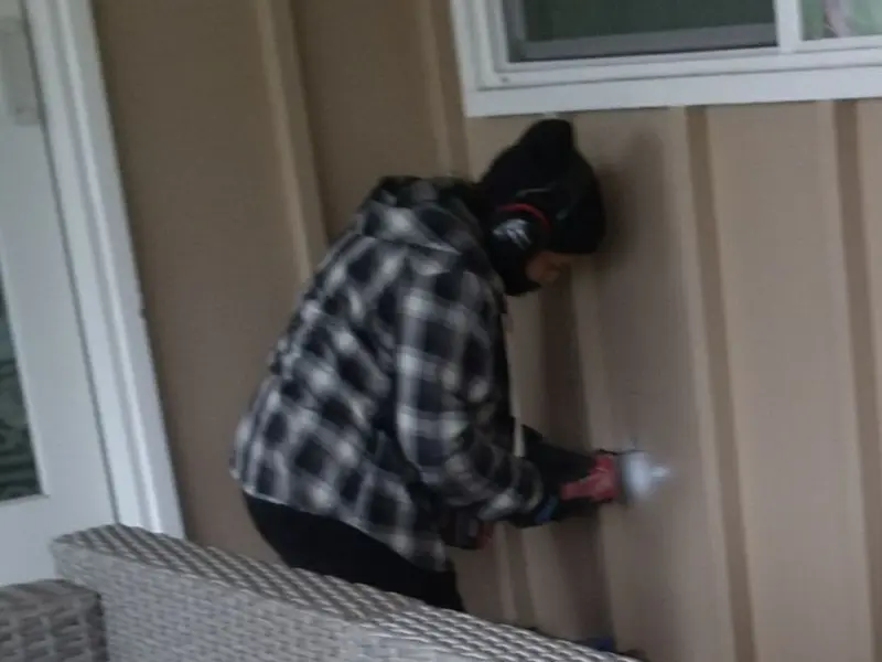Professional electrician installing an exterior outlet in Farmingdale